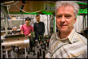 Professor Eugene Polzik in the quantum optics laboratory with the experiment setup in the background