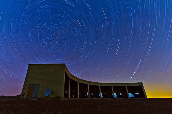 n this time-lapse photo, stars appear to rotate above the Middle Drum facility of the Telescope Array
