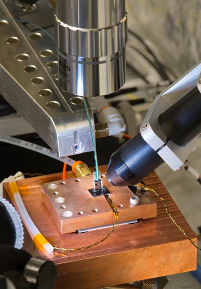 The positioning platform used to align and bond the optical fiber array to the surface of a photonic chip