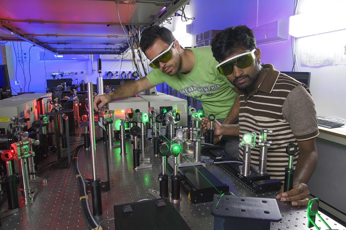 Researchers perform an experiment in Femtosecond laser laboratory