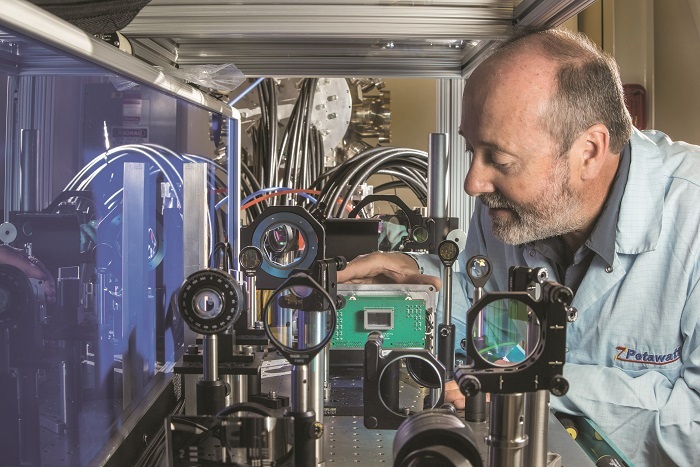 Sandia National Laboratories physicist John Porter carefully sets in place an ultrafast multiframe digital X-ray camera — the fastest in the world — in Sandia’s Z-beamlet laser facility