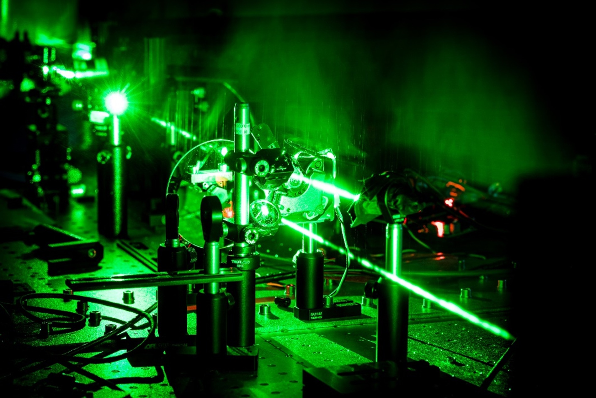 This image captures a laser beam interacting with polariton microcavities, revealing how polaritons help protect emitting materials from brightness loss.