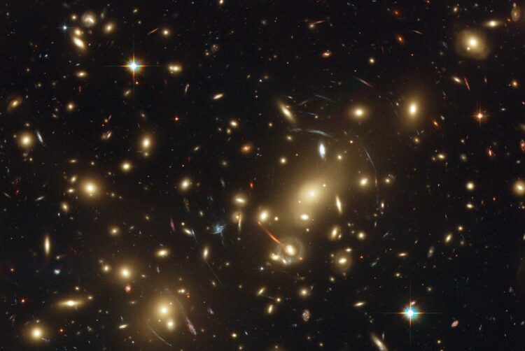 Image of Abell 2218, a dense galactic cluster approximately 2 billion light years from Earth.