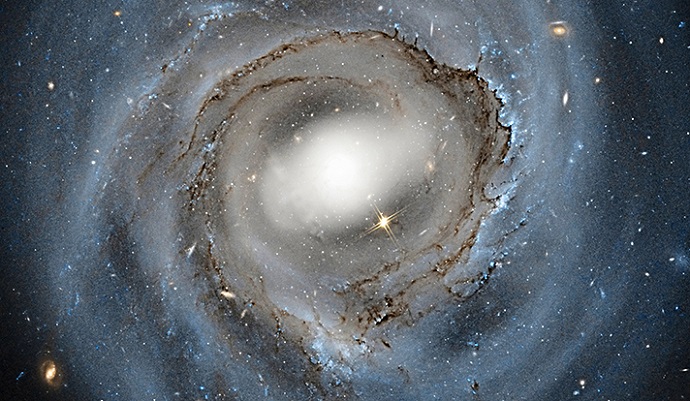 This Hubble Space Telescope image of a spiral galaxy in the Coma cluster highlights dust extinction features