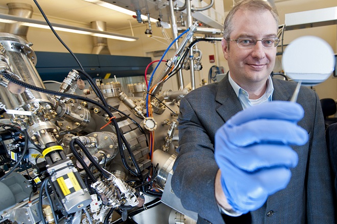 Purdue professor Michael Manfra holds a gallium-arsenide wafer