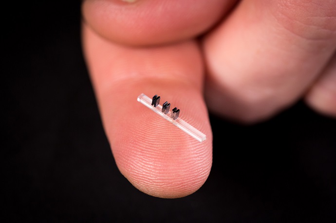 Three accelerators on a chip made of silicon are mounted on a clear base