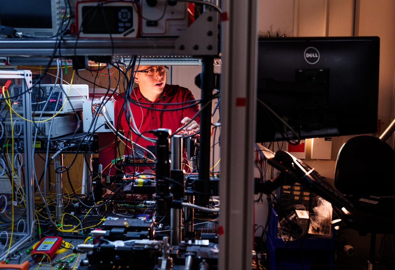 Sandia National Laboratories physicist Nils Otterstrom works to align an integrated photonics chip at the quantum photonics lab.