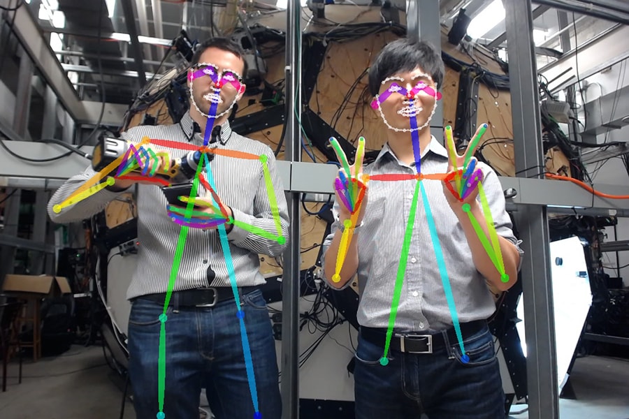 Robotics Institute researchers Gines Hidalgo Martinez and Hanbyul Joo demonstrate how a real-time detector understands hand gestures and tracks multiple people.