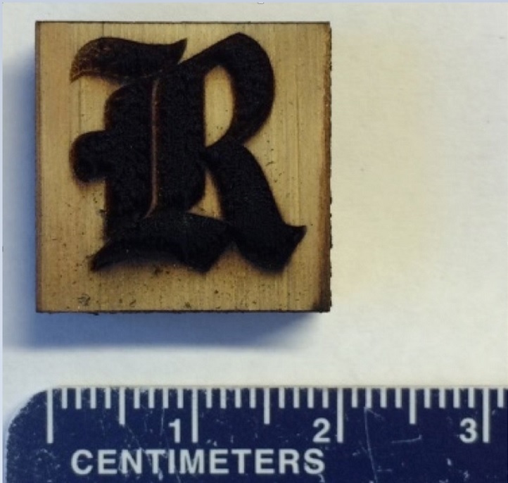 This Rice University athletics logo is made of laser-induced graphene on a block of pine