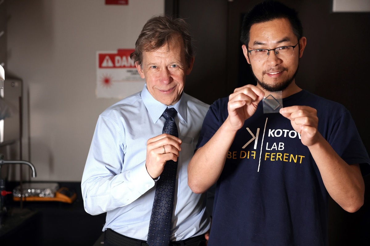 Nicholars Kotov, the Irving Langmuir Distinguished University Professor of Chemical Sciences and Engineering, and Jun Lu, an adjunct research investigator, present their light-twisting materials in their chemical engineering laboratory.