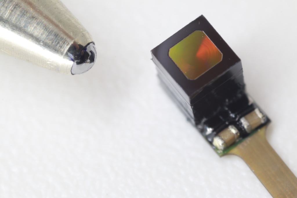 NILT metaCamera™ next to the tip of a ballpoint pen.