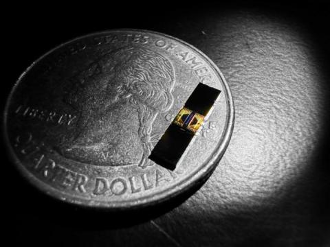 The small chip sitting on the quarter holds a tiny track for light to race around—a device that facilitates precision measurements of light
