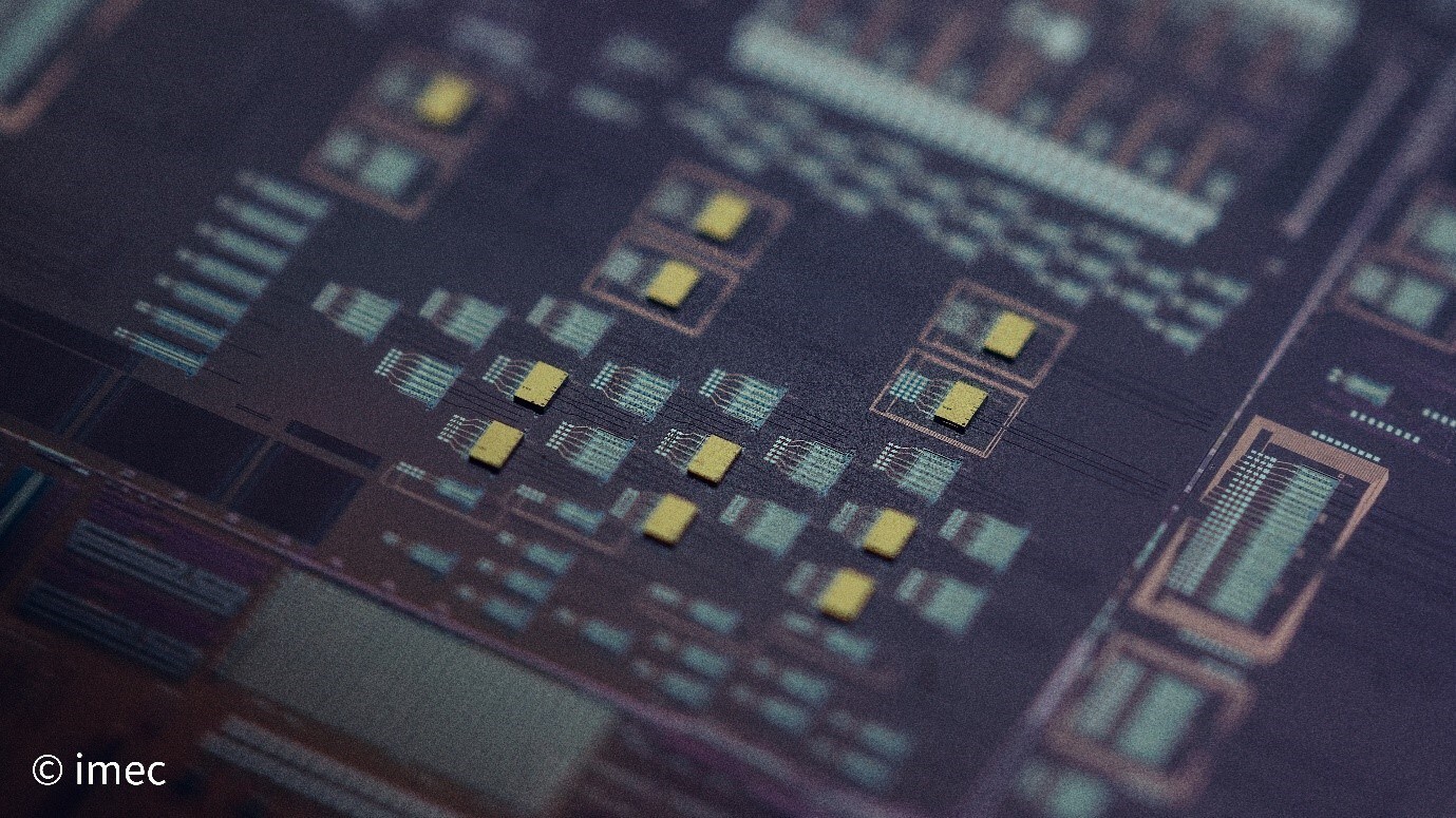 Picture of IMEC 300 mm Si photonic wafer with InP laser dies bonded on top. class=