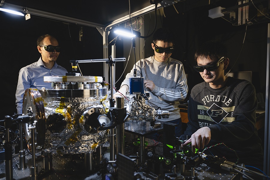 Prof. Tongcang Li, Dr. Yuanbin Jin and Kunhong Shen perform experiments with levitated and rotating fluorescent diamonds at Purdue University.