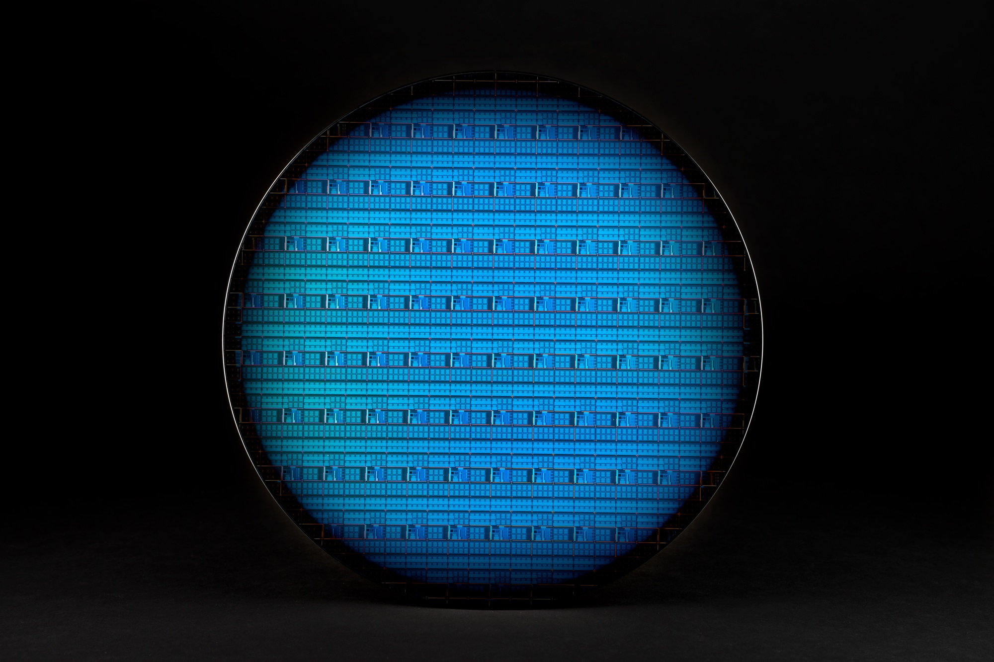 A photo shows a 300-millimeter Intel silicon spin qubit wafer
