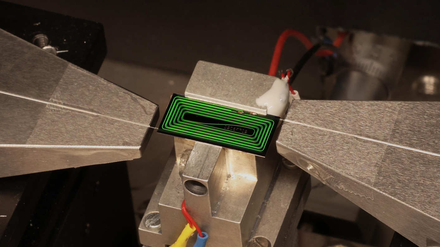 EPFL's chip-based ultrafast laser operating in the laboratory test setup. The device produces extremely short laser pulses directly on a photonic chip.