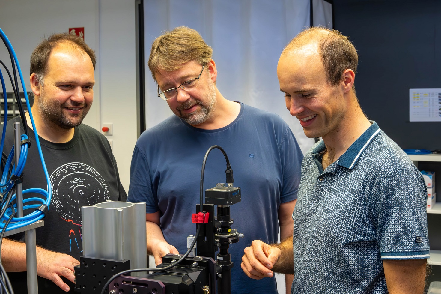 Matthias Heinrich, Alexander Szameit and Max Ehrhardt - the authors of the Science paper - experimenting with photonic circuits